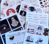 Chronicles of a Ghost ephemera sheets fanned out. Vintage ghost postcards, tags and Halloween word labels.