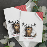 Two handmade Christmas cards featuring the grumpy antlered cat stamped in black with red gingham accents and the 'Merry Whatever' sentiment.