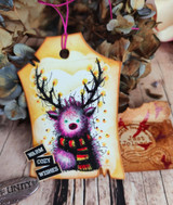Kraft tag with a purple-toned deer in a scarf and "Warm cozy wishes"