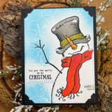 A top-hatted snowman in a scarf stamped in red rubber and colored on a handmade card reading "You put the merry in my Christmas."
