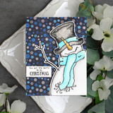 A top-hatted snowman in a scarf hand-stamped on a card and lettered "You put the merry in my Christmas."