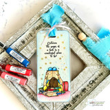 Shimmery bookmark of the reading girl with 'Between the pages of a book is a wonderful place to be' among tiny stars.