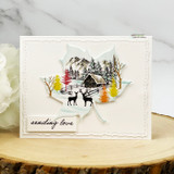 Cream card with the cabin scene stamped on a die-cut maple leaf, deer and autumn trees, 'sending love' tag.