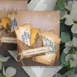 Two cards made with the Distressed Tickets dies — die-cut ticket banners reading 'warm wishes' over snowy landscapes.
