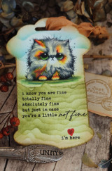 Tag-shaped card featuring the sad kitten colored with orange eyes, captioned 'just in case you're a little not fine, I'm here.'