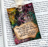 Mixed-media card on a Bible page with a cross and 'The Lord bless you and keep you.'