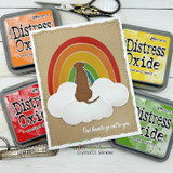 Kraft card with a dog silhouette on a cloud beneath a rainbow, 'Our hearts go out to you.'