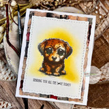 Card with the sad-eyed puppy on a sunny yellow blended background over plaid, the love sentiment beneath.