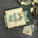 Dark green starry card with a distressed kraft panel of three sketchy pine trees and green stars above 'Holly jolly wishes', with a matching gift tag.