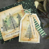 Close-up of the pine tree card and a stitched kraft gift tag with a shimmering tree and 'A little gift for you'.
