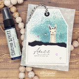 Kraft tag card with the little llama on a teal-splattered panel and 'Admit it. Life would be boring without me.'