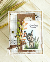Layered kraft card with the donkey among grasses and florals and "Sending a smile"