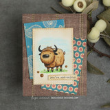 Fuzzy brown highland yak on grass, 'you're moo-velous,' on blue and pink patterned papers with a kraft border.