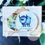 Blue-toned yak in a stitched circle, 'that's some bullshit,' on a white card with twine.