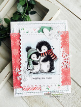Snowflake-trimmed red card — penguins hugging tight with candy cane accent