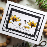 Black-framed card with bold yellow daisies and a thank-you sentiment on a white panel