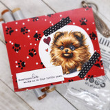 Red paw-print card of Bradley peeking from a circle frame with black washi