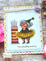 Card with the woman in a yellow tutu beside the cake, captioned 'You're just getting warmed up.'