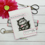 Card featuring the grumpy cat with its tongue out holding a heart, captioned 'Happy Valentine's Day!'