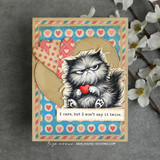 Card featuring the fluffy grumpy cat with a red heart on blue and red heart-print paper, captioned 'I care, but I won't say it twice.'