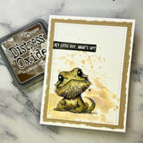 Splatter-washed card of Bruce beside a walnut Distress Oxide ink pad.