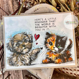 Watercolor card of a puppy and the calico kitten with a heart: 'the world is brighter with you in it.'