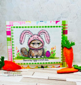 Colorful Easter card with the grumpy bunny-eared cat, carrots and an egg, captioned 'This is my egg-cited face.'