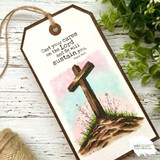 Pastel tag with the wildflower cross — cast your cares on the Lord