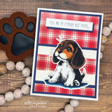 Plaid card with the beagle puppy framed in navy over red-and-blue buffalo check with a paw die-cut.