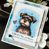Card with a blue watercolor sky and speckled border; Mari is colored in warm browns with a painted blue heart beside the 'just because' sentiment.