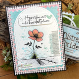 Wounds & Blooms card, the lone flower colored soft coral or purple over an inky distressed background, 'Every wound can bloom into wisdom'.
