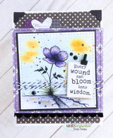 Wounds & Blooms card, the lone flower colored soft coral or purple over an inky distressed background, 'Every wound can bloom into wisdom'.