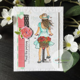 White embossed-frame card with a sun-hatted girl walking her flower-filled bicycle, mint dress, pink fabric rose and washi strips, sentiment 'Trust the journey.'