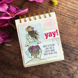 Pastel spiral-bound journal page with the girl and her flower bicycle on a torn-edge panel, a red 'yay!' die cut, and the light-and-free sentiment strip.