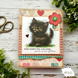 Card with Pookie the kitten on gingham paper trimmed with hearts and a flower, stamped 'Some hearts feel like home, yours is one of them.'