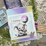Baby elephant with a purple balloon on a lavender embossed card, captioned "Big birthday wishes!"