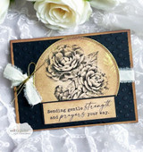 Navy and kraft card with a gold embossed circle, two camellia blooms stamped in black line art, sheer bow, sentiment 'Sending gentle strength and prayers your way.'