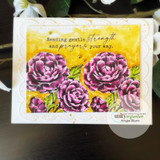 Scalloped white card with a golden yellow inked panel, camellias coloured in magenta and purple with green leaves, sentiment 'Sending gentle strength and prayers your way.'