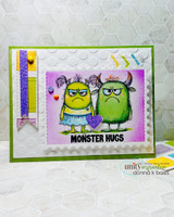 Purple and green card with two monsters side by side and a bold 'MONSTER HUGS' banner.