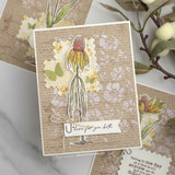 Card with a coneflower over floral papers and 'here for you both.'