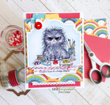Handmade card with the fluffy gray cat colored among paints and washi tape, stamped 'I expect tears & a fridge display,' on rainbow-striped patterned paper.
