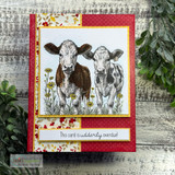 The two cows colored on a card with a red and floral panel — 'this card is udderly overdue.'