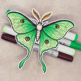 The luna moth colored in fresh green, fussy-cut and staged with markers.