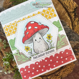 Yellow and green card with a hexagon frame and a red scalloped border, the smiling toadstool coloured red with daisies, sentiment 'Feel better shroom!'.