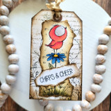 Vintage tag with a pink bird on a daisy and a 'Chirps & cheer' banner.