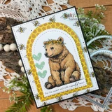 Sample card with the flower-crowned bear cub colored golden brown inside a honeycomb arch, green heart accents and a bee-printed border, stamped 'For the sweet soul with a wild heart'.