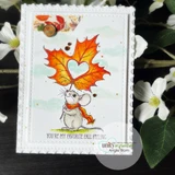 Card with the mouse holding a vivid orange maple leaf on a soft watercolour sky panel with a scalloped stitched border and the you're my favorite fall feeling sentiment.