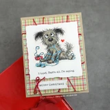 Sample card using the pack: a red and green plaid mat behind a stamped shaggy dog tangled in red thread, with a merry christmas sentiment.