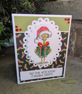 Chicken in a Santa hat holding a present on a dark floral card, 'cluckin cheerful'.