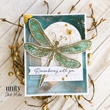 Teal card with a die-cut dragonfly over gold accents, 'Remembering with you'